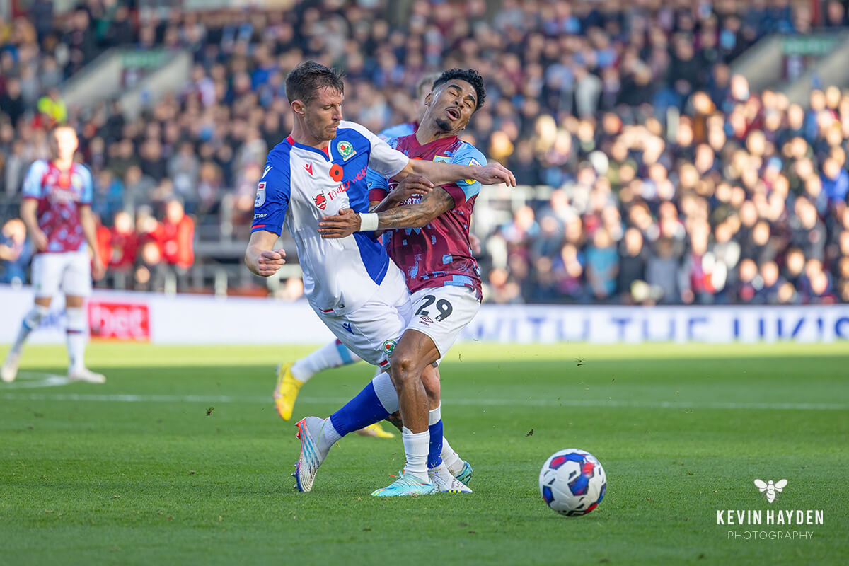 Burnley's Ian Maatsen gets tackeled by a Blackburn player at Turf Moor, Burnley. Photo by Kevin Hayden.