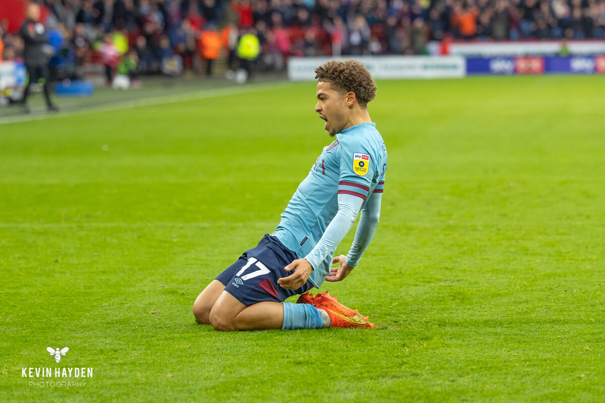 A Reading player slides in on Burnley's Nathan Tella in an EFL Championship game at Turf Moor, Burnley. Photo by Kevin Hayden.